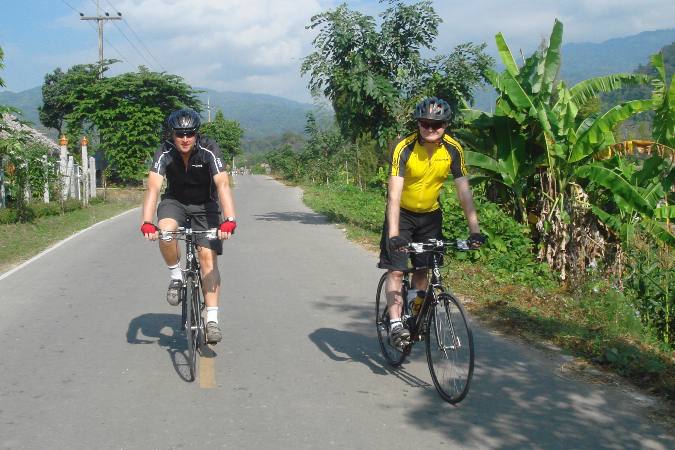 bicyclists on rural road during Thailand tour