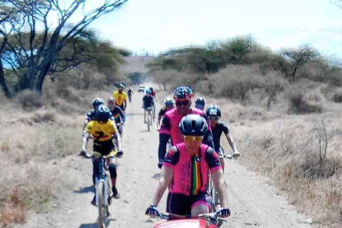 cyclists on dirt road in game park
