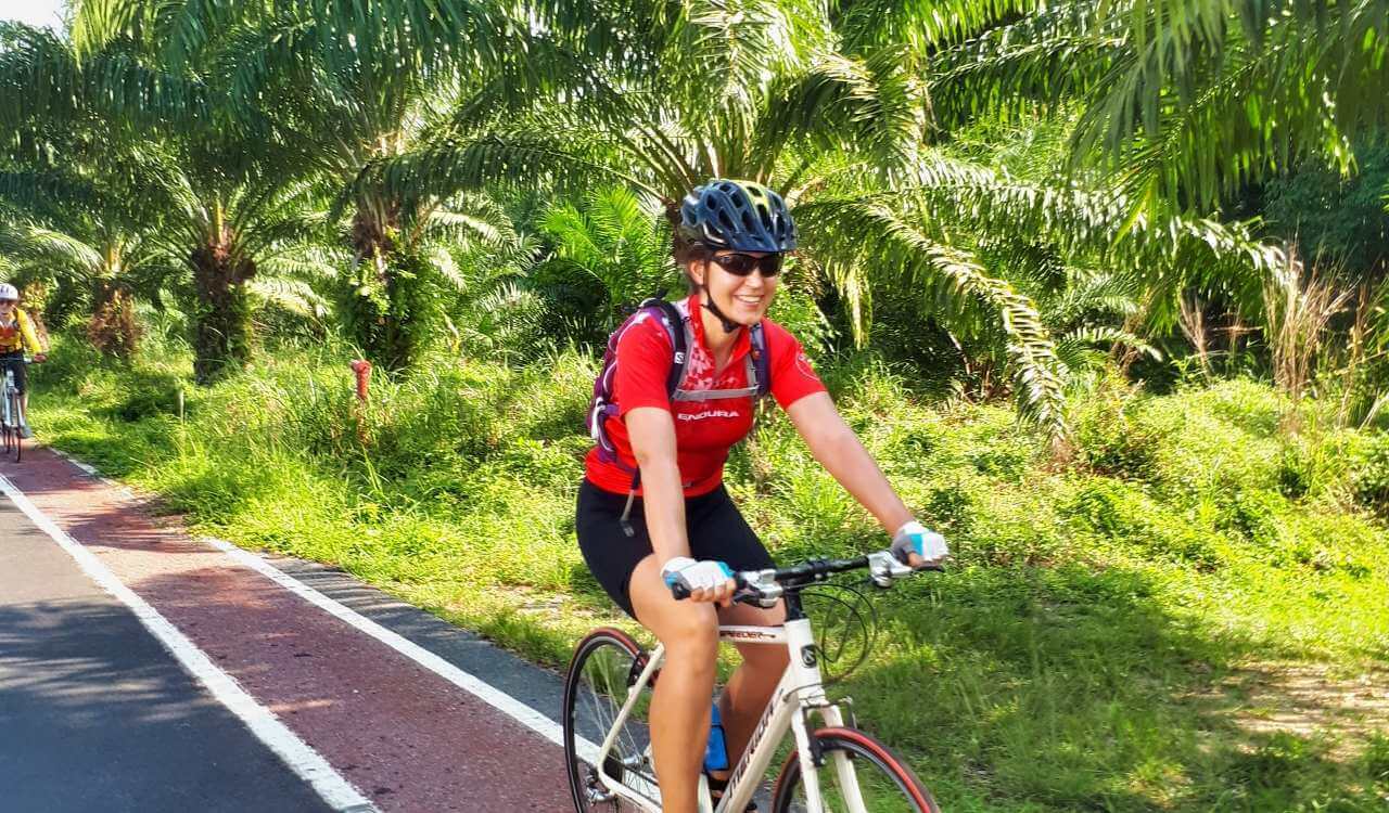 Cycling in Thailand past tropical forests.